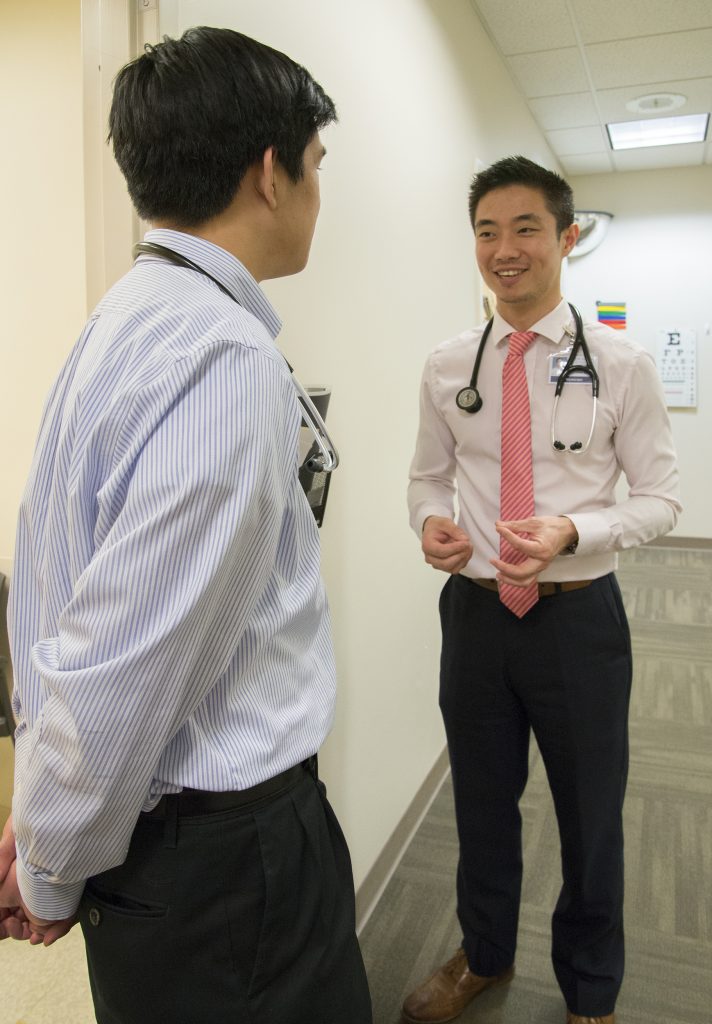First year medical student with preceptor in hallway