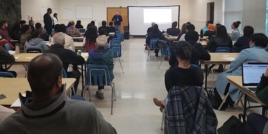 photo of a teacher in front of a class of students