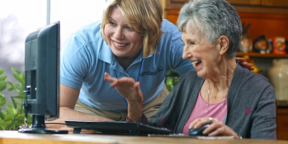 Photo of two people looking at a computer screen