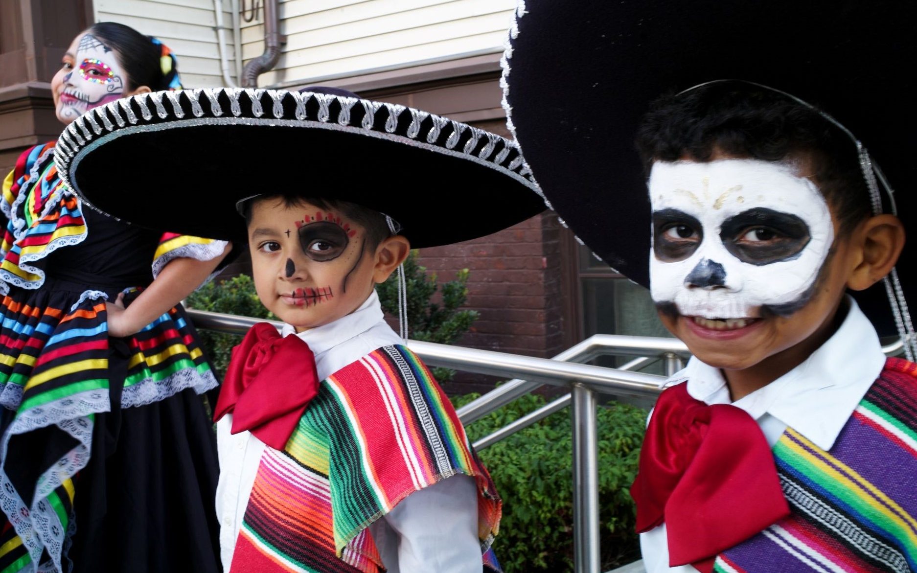 Photo of two boys dressed for Dia de los Muertos