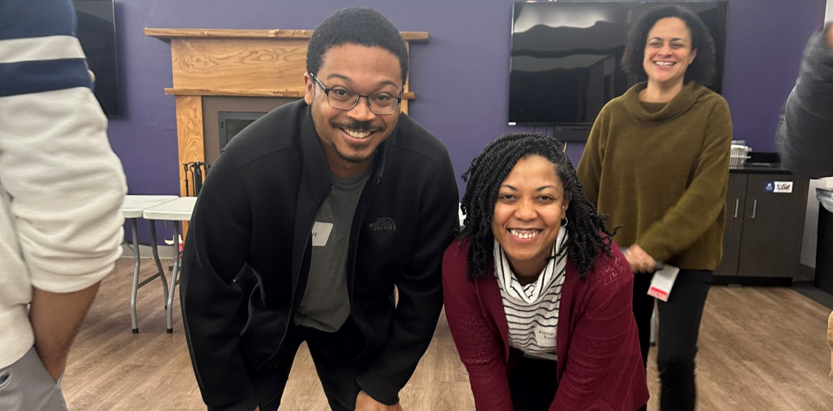 Photo of CMFA members bending down and smiling